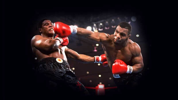 Mike Tyson delivering a powerful punch during a boxing match, 4K Desktop Wallpaper