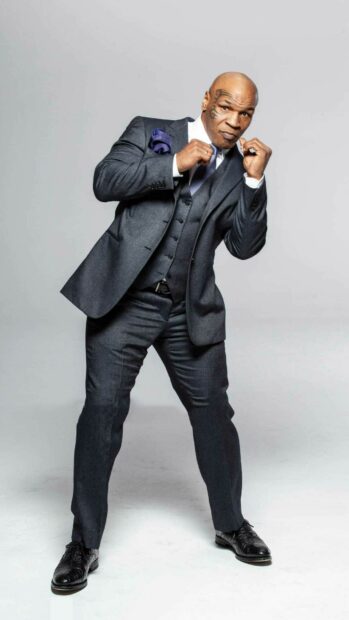 Mike Tyson in a suit showing a classic fighting stance and confident attitude, HD Phone Wallpaper