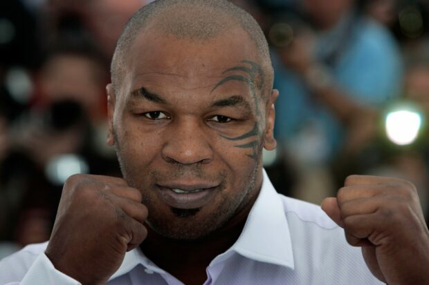Mike Tyson is posing with his fists raised and a confident expression, 2K Desktop Wallpaper