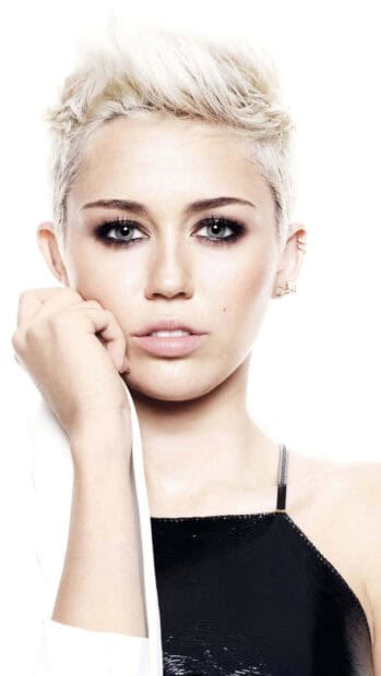 Miley Cirus shows a serious expression with short blonde hair and smoky eye makeup, HD Mobile Wallpaper