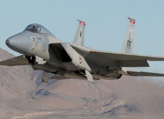 The jet fighter is flying low above a dry mountain range with clear skies, HD Desktop Wallpaper