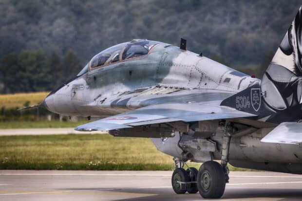 Military jet fighter on runway Jet fighter parked on the runway with a forest background jet fighter wallpapers hd Desktop Wallpaper