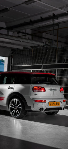 A Mini Cooper Clubman is parked inside a garage showing its rear lights and design details, HD Phone Wallpaper