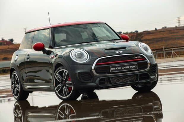 A Mini Cooper John Works parked with reflections on wet ground, HD Desktop Wallpaper