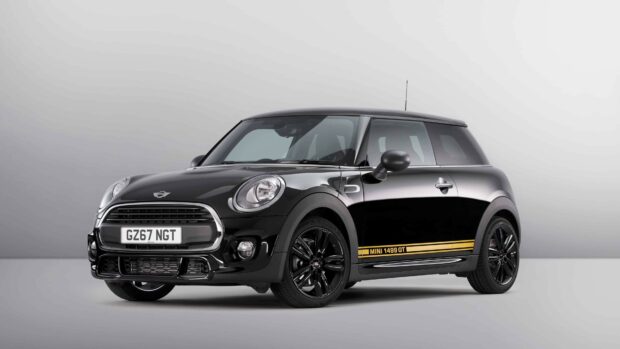 A black Mini Cooper 1499 GT is parked in a studio setting, 4K Desktop Wallpaper
