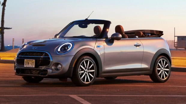 A silver Mini Cooper convertible is parked on an empty lot during sunset, HD Desktop Wallpaper
