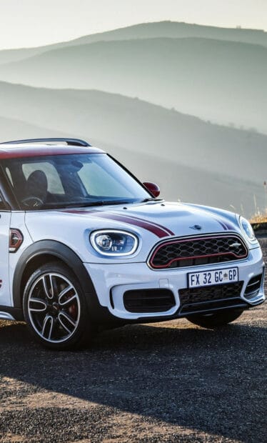 A white Mini Cooper with red accents parked on a mountain road, HD Phone Wallpaper