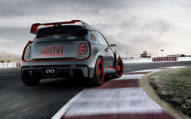 A Mini Cooper is speeding around a racing track with red accents, 2K Desktop Wallpaper