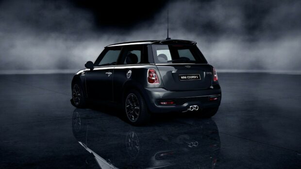 A black Mini Cooper is shown from the rear with reflections on the floor and a foggy background, HD Desktop Wallpaper