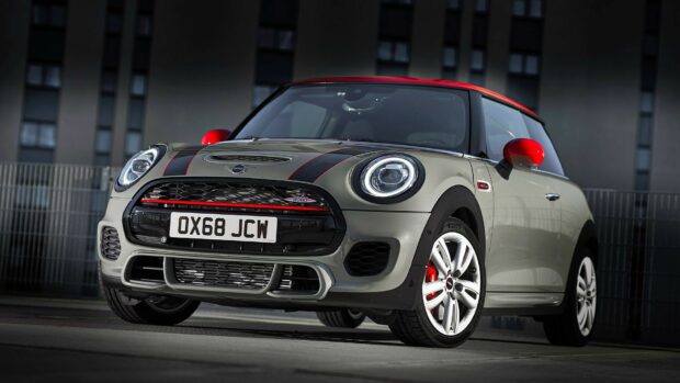 A Mini Cooper with red accents is parked outdoors near a modern building, HD Desktop Wallpaper