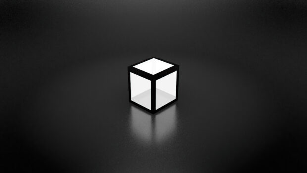 A glowing cube with black edges is placed on a dark textured surface reflecting light, 4K Desktop Wallpaper