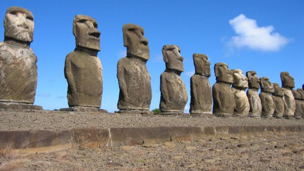 Moai statues standing in a row on Easter Island under a blue sky, HD Desktop Wallpaper