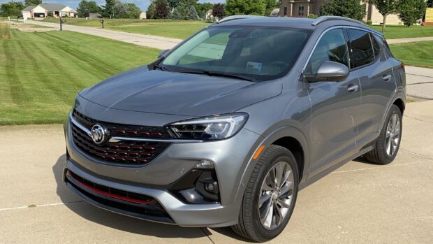 A silver Buick Encore with black and red grille details parked outside a house, 2K Desktop Wallpaper