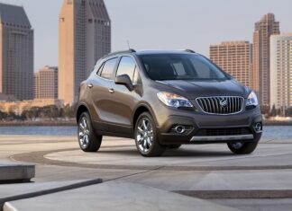 The Buick Encore is shown parked near waterfront with city skyline in the background, HD Desktop Wallpaper