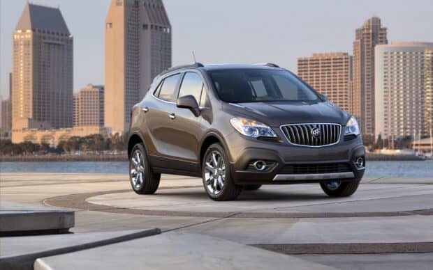 The Buick Encore is shown parked near waterfront with city skyline in the background, HD Desktop Wallpaper