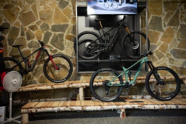 Modern Cube Bikes displayed indoors with stone wall background in a showroom, HD Desktop Wallpaper