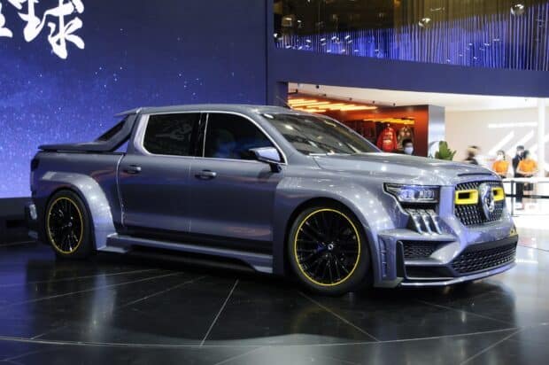 A sleek Great Wall Motors pickup truck showcased at an exhibition with metallic paint and yellow accents, HD Desktop Wallpaper