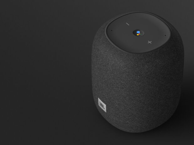 A modern JBL speaker with fabric texture features smart assistant controls on top, HD Desktop Wallpaper