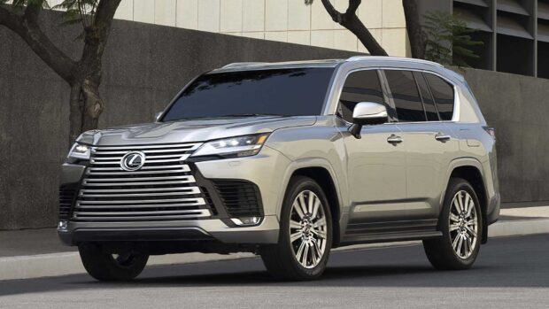 A silver Lexus LX parked outside with urban buildings in the background, HD Desktop Wallpaper