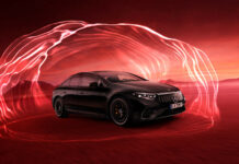 A black Mercedes Benz Eqs is displayed with flowing red light effects in a desert setting at dusk, HD Desktop Wallpaper