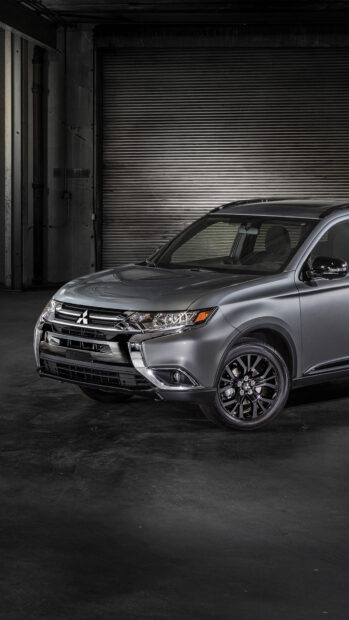 A sleek gray Mitsubishi Outlander is parked inside a dimly lit garage showing its front side, 4K Mobile Wallpaper