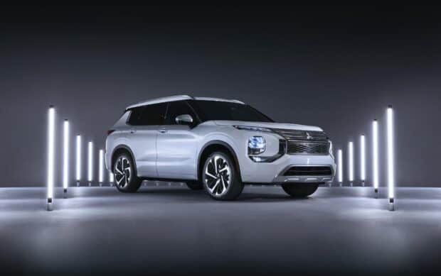 A white Mitsubishi Outlander stands among vertical light tubes in a dark room showcasing its design, HD Desktop Wallpaper