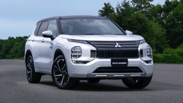 Modern Mitsubishi Outlander in white SUV parked on paved road near green trees, HD Desktop Wallpaper