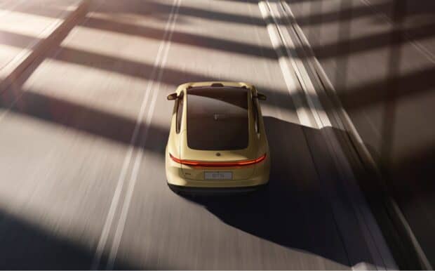 A yellow Nio Auto drives smoothly under shadows on the road in this Nio Auto Wallpapers, HD Desktop Wallpaper