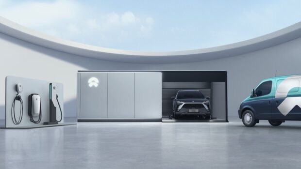 A sleek Nio electric car charges at a futuristic station under a curved skylight, HD Desktop Wallpaper