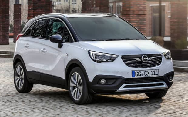 A modern Opel Crossland drives on a cobblestone street in the city, HD Desktop Wallpaper