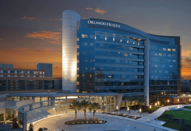 The Orlando Health building stands tall against the colorful sunset sky in this Orlando Wallpapers image, HD Desktop Wallpaper