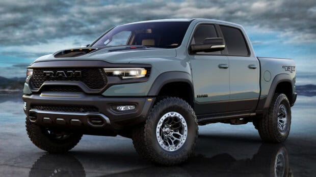 Modern Ram pickup truck is displayed on a reflective surface with a cloudy sky background, HD Desktop Wallpaper