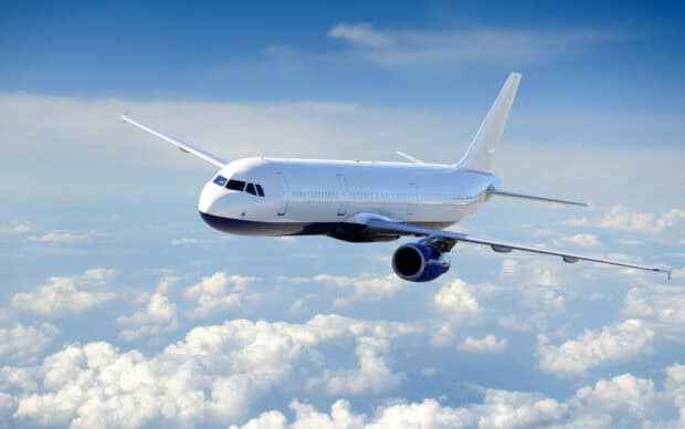 A modern aircraft flying above white clouds with a blue sky in the background, HD Desktop Wallpaper