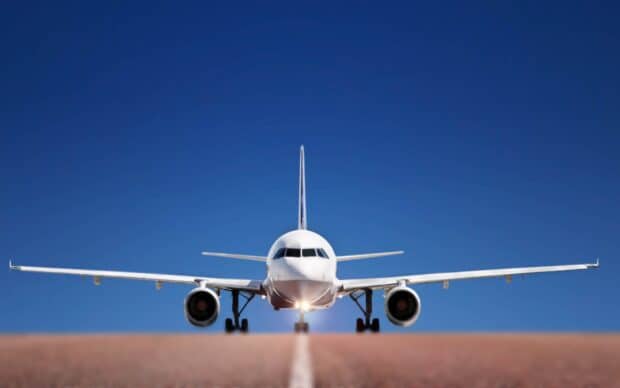 A modern aircraft is taxiing on the runway with a clear blue sky, 2K Desktop Wallpaper