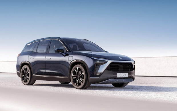 A modern electric SUV by Nio Auto is parked on a clear day under a blue sky, HD Desktop Wallpaper