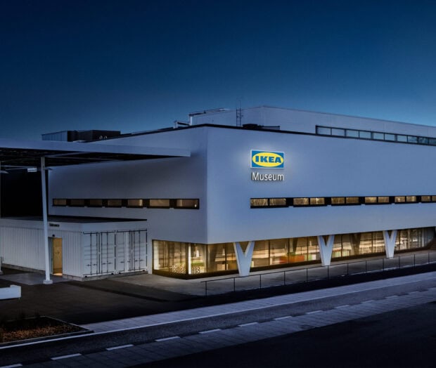 The Ikea Museum building is shown with illuminated windows and clear signage during night time, HD Desktop Wallpaper