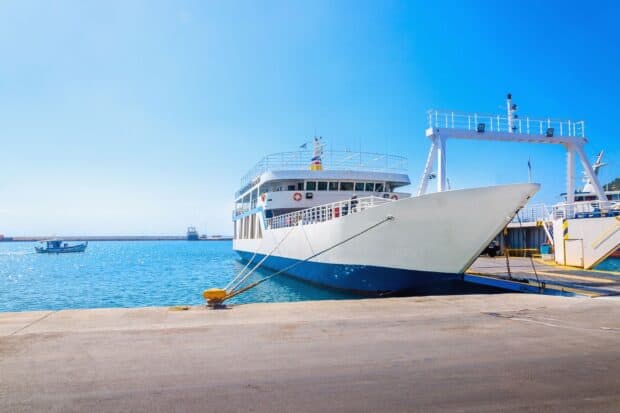 A ferry is securely tied at the harbor with clear blue water in the background, HD Desktop Wallpaper