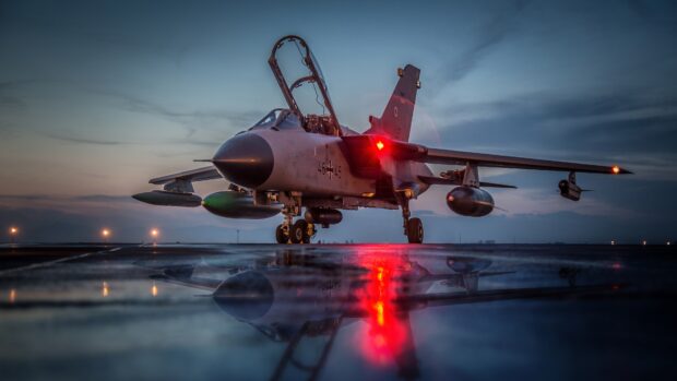 A jet fighter sits on the runway with its cockpit open under a dusky sky, 4K Desktop Wallpaper