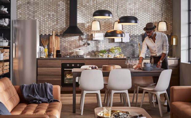 A modern kitchen features Ikea Wallpapers and a man arranging tableware, HD Desktop Wallpaper