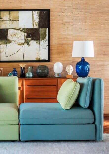 A modern living room features Ikea Wallpapers with colorful furniture and artistic decor, 2K Desktop Wallpaper