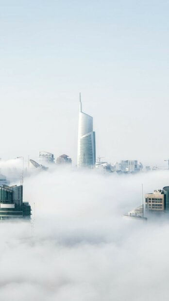 The United Arab Emirates skyline rises through the fog in a clear morning, HD Phone Wallpaper