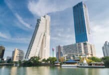 The image shows modern skyscrapers with a lake in Colombo Sri Lanka cityscape, HD Desktop Wallpaper