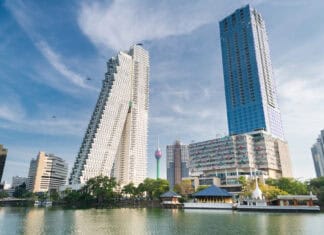 The image shows modern skyscrapers with a lake in Colombo Sri Lanka cityscape, HD Desktop Wallpaper