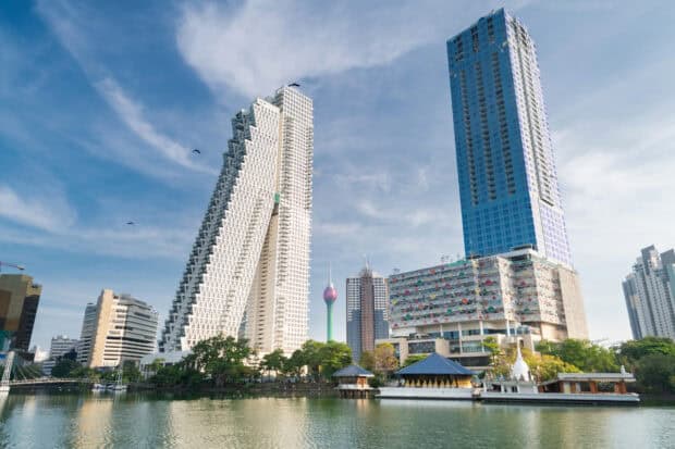 The image shows modern skyscrapers with a lake in Colombo Sri Lanka cityscape, HD Desktop Wallpaper