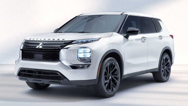 A modern white Mitsubishi Outlander stands prominently showcasing its bold front grille and headlights, HD Desktop Wallpaper
