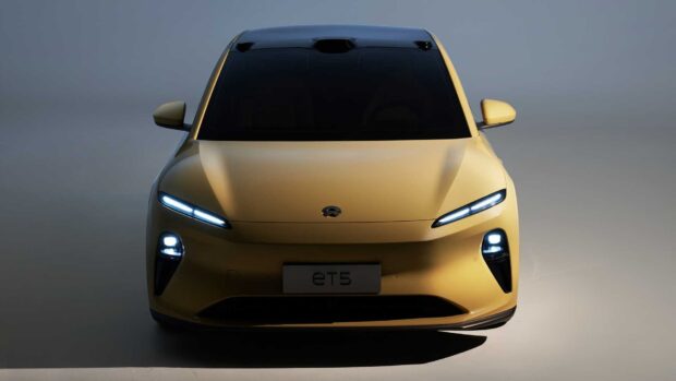A yellow electric car of Nio Auto is shown with lights on in the front, HD Desktop Wallpaper
