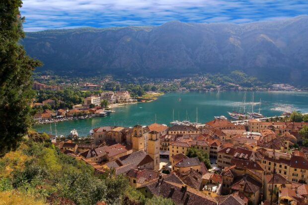 A scenic view of a Montenegro town with boats and mountains, 2K Desktop Wallpaper