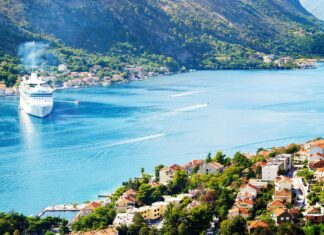 The Montenegro coastline shows a cruise ship near a coastal town surrounded by green mountains, 4K Desktop Wallpaper