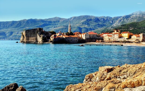 A coastal town in Montenegro features historic buildings and mountains in the background, HD Desktop Wallpaper