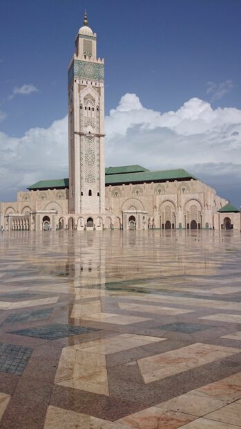 The Morocco tower shows detailed patterns and arches under a blue sky, 2K Mobile Wallpaper